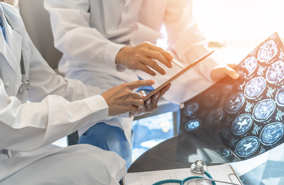 Doctors reviewing brain scan images together
